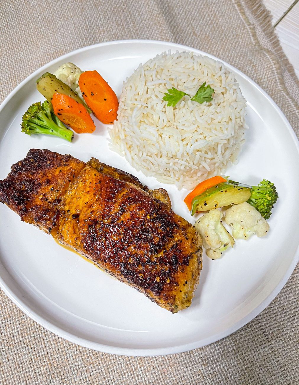 Pan-seared salmon fillet with rice and garden vegetables